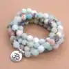 Bijou Spirituel Collier Mala Amazonite. | OkO-OKO™ Collier Mala Amazonite mantra Om sur table| oko oko