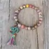 <br> Pulsera de joyería espiritual Om Mani Padme Hum. | OkO-OKO™ Pulsera Om Mani Padme Hum sobre mesa de madera | oko oko