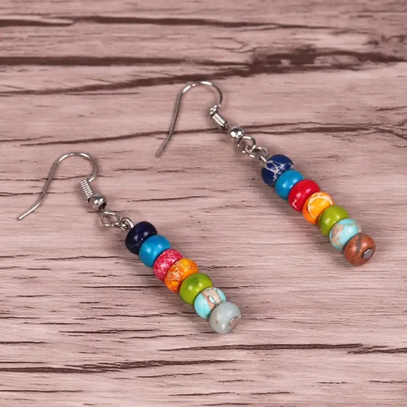 7 chakras earrings placed on table oko oko