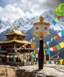 Close-up of a brass moulin priere tibetain mantras with a dark wooden handle against a scenic mountain temple backdrop