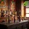 Molinillo de oración tibetano con mantras grabados | OkO-OKO™ Tres molinillos de oración tibetanos de latón con diferentes acabados metálicos descansan sobre una mesa de altar de madera rústica oscura