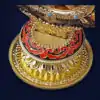 Roue du Dharma dorée ou Dharmachakra aux détails précieux et dorés | OkO-OKO™ Close-up of the ornate gold base of a roue dharma doree dharmachakra featuring red enamel patterns and intricate carvings